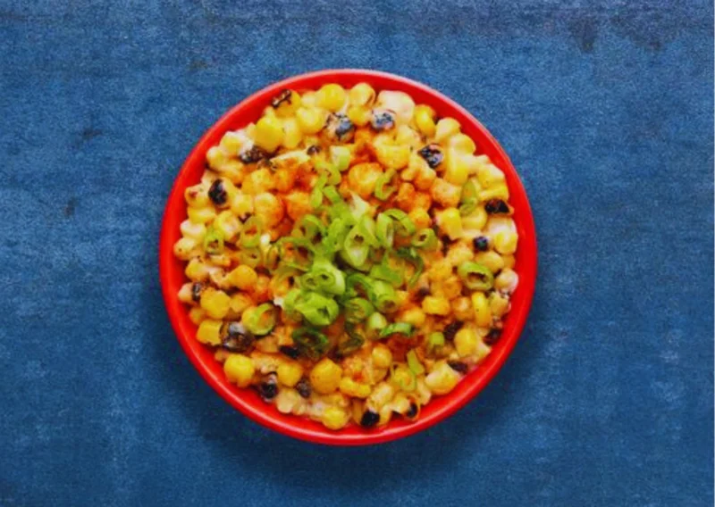 Smoky sweetcorn in a creamy, garlicky sauce topped with fresh spring onions and a sprinkle of PERi-Salt.